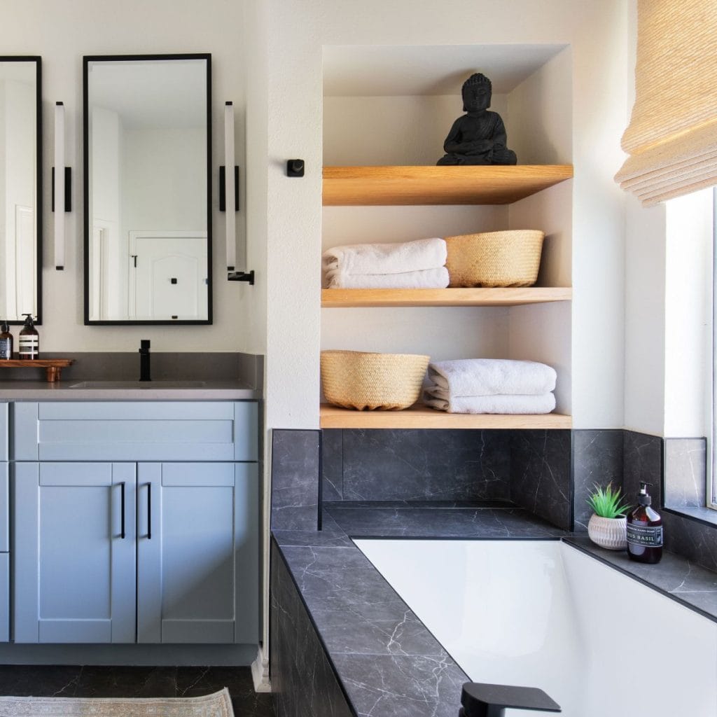 Bathroom design with shelving, vanity, and bathtub 