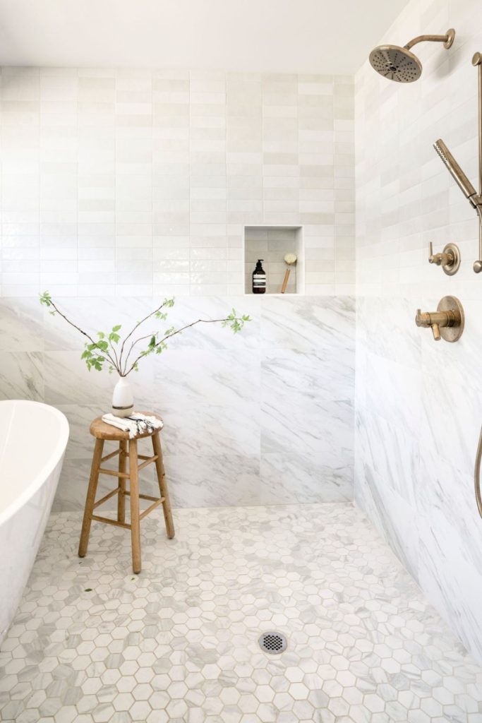 Marble Bathroom Floor with Freestanding Tub and plant